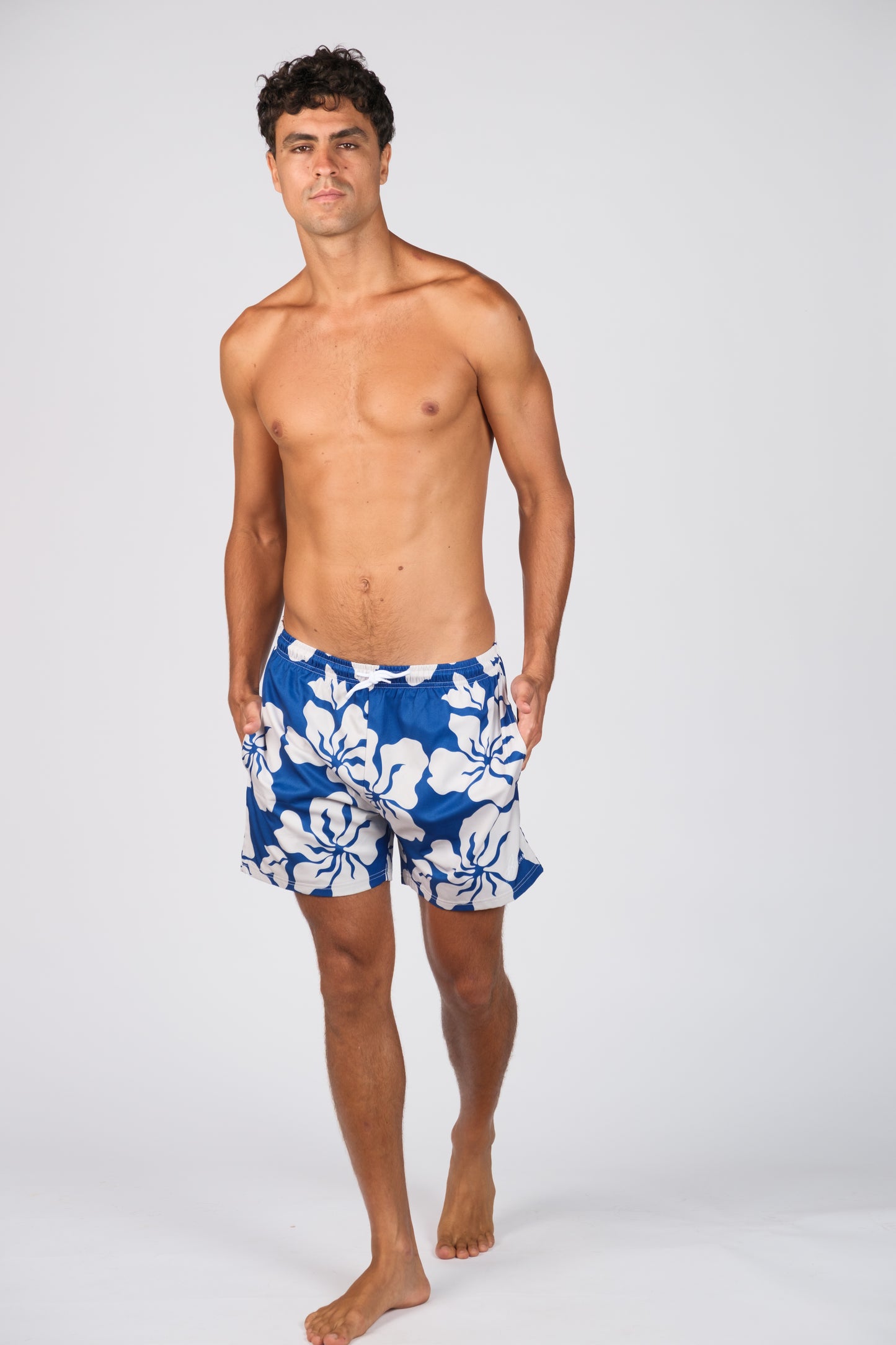 BILLY ALOHA HAZE SWIM TRUNKS. BLUE AND WHITE HIBISCUS PRINT.