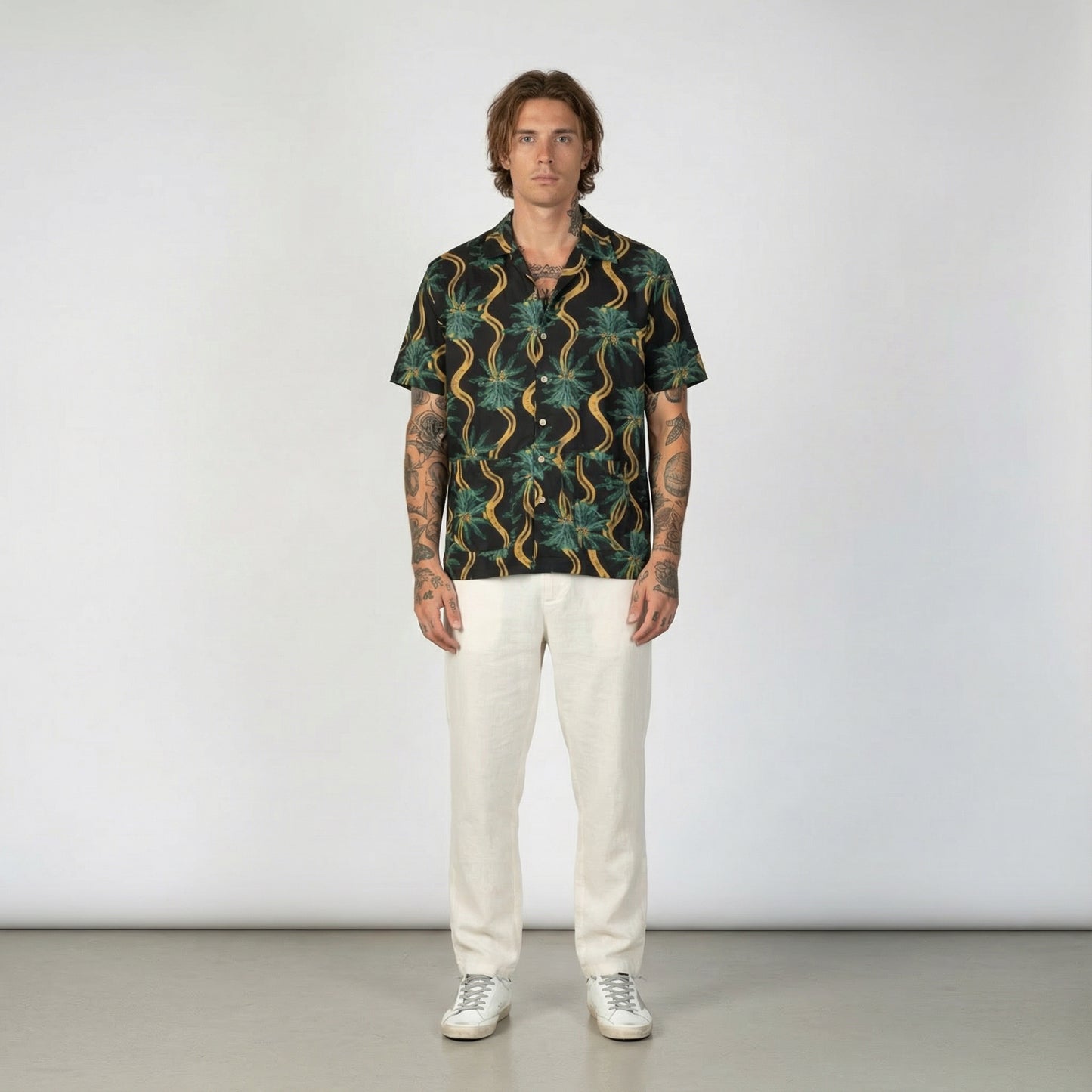Delirium Shirt. Short-sleeve shirt with a tropical pattern on a white background