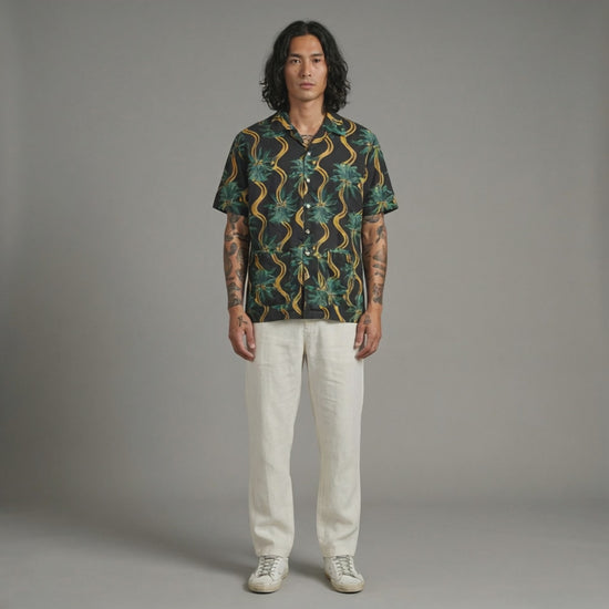 Delirium Shirt. Short-sleeve shirt with a tropical pattern on a white background